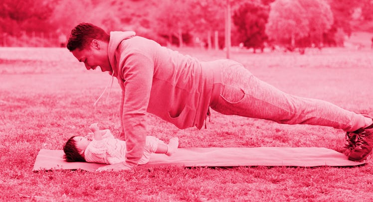 A man doing father-daughter yoga with his baby girl in a park