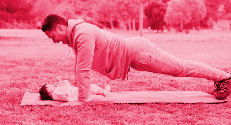A man doing father-daughter yoga with his baby girl in a park  