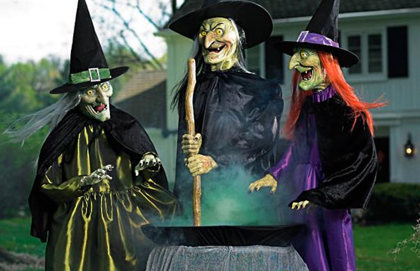 The Grandin Road Animated Brewing Witch Trio featuring two grey-haired and a red-haired witches stir...
