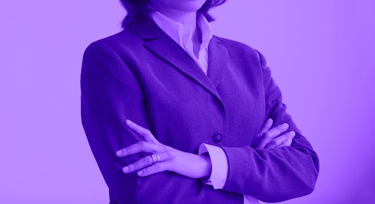 A woman posing in a blazer and white button-up