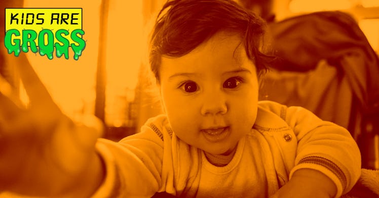 A toddler kid looking at the camera
