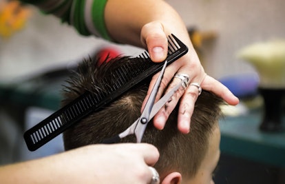 A boy at his barber before his first day of school