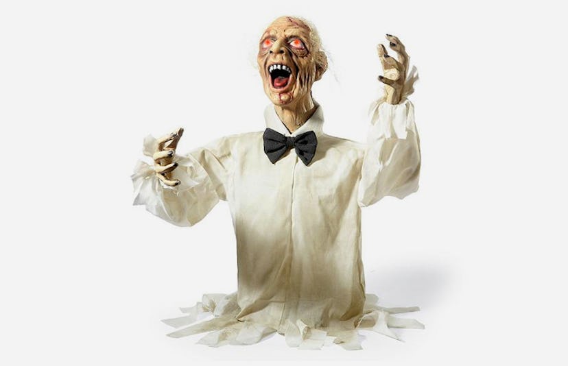The Grandin Road Henry the Zombie in a white shirt and a black bow with his hands up with a scary fa...