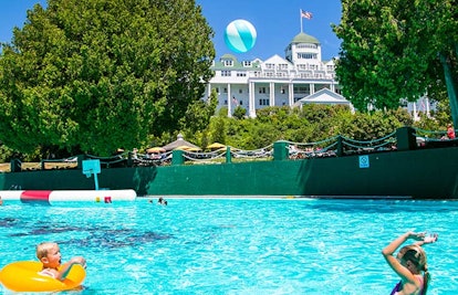 A mother playing with her child in a swimming pool at the Grand Hotel Mackinac Island