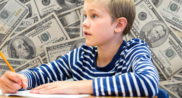 A child sitting and writing something down with various dollar bills in the background