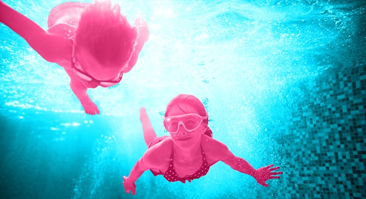 Two kids playing swimming pool games while diving