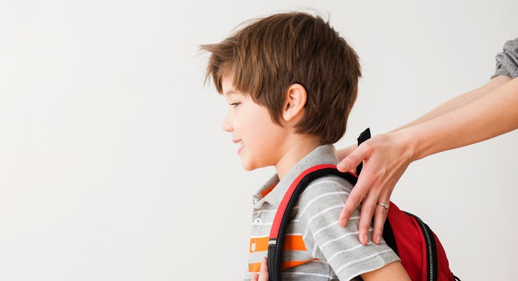 A boy going to school for the first time with a backpack
