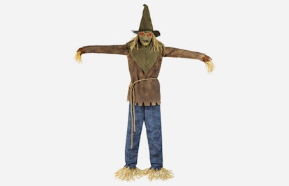 The Spirit Looming Strawman wearing a brown shirt, blue denim jeans, and a green hat
