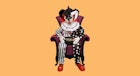 Spirit Sitting Scare Clown in a red and black striped armchair holding a bowl with candies in his la...