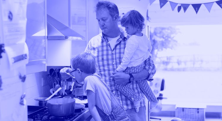 A father cooking in the kitchen with his two kids while being a solo parent for seven days