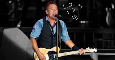 Bruce Springsteen playing a guitar and singing