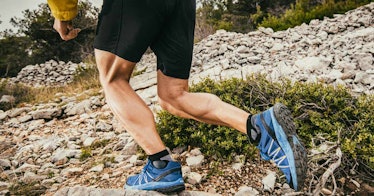 Close up shot of a man jogging, with emphasis on his big calves.