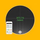 A bathroom scale and and a phone displaying results