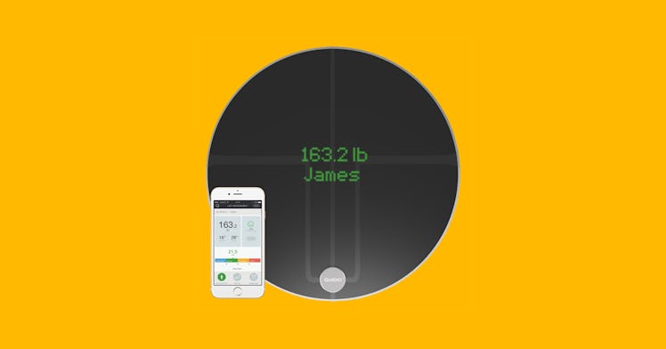 A bathroom scale and a phone displaying results