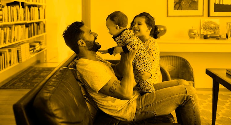 A happy dad being playful with his children after splitting with his co-parent