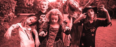 A group of children wearing zombie make up and costumes