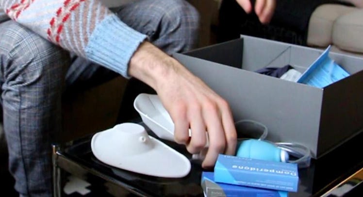 A man unpacking a man's nursing kit.