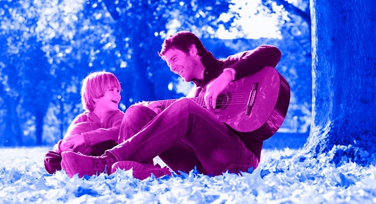 pink and blue edit of dad sitting in grass playing camp songs on guitar with 8-year-old son