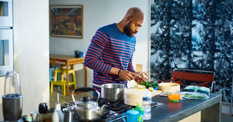 A husband preparing a meal for his breastfeeding wife in a kitchen