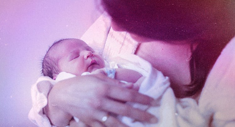 A woman who is experiencing post-baby grief holding her sleeping newborn in her arms