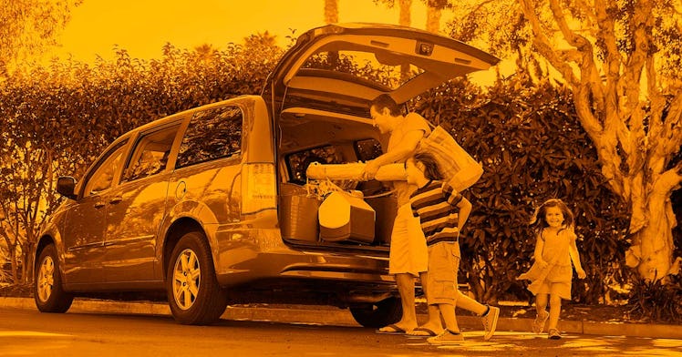 Family carrying out stuff from the trunk of their family minivan