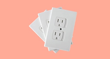 Baby-proofing outlet covers set against a peach backdrop.