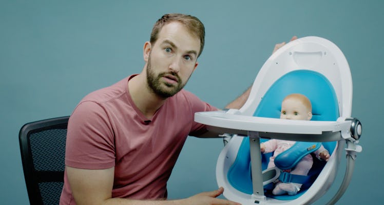 Evan Kaufman posing next to a doll in the Bloom Fresco High Chair