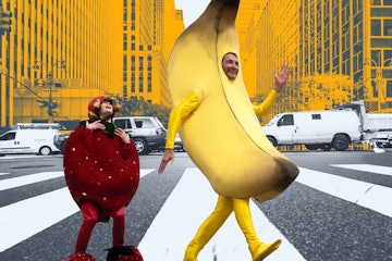 Dad and son in banana and strawberry costumes crossing the road.