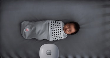 A small baby sleeping with Nanit breathing wear
