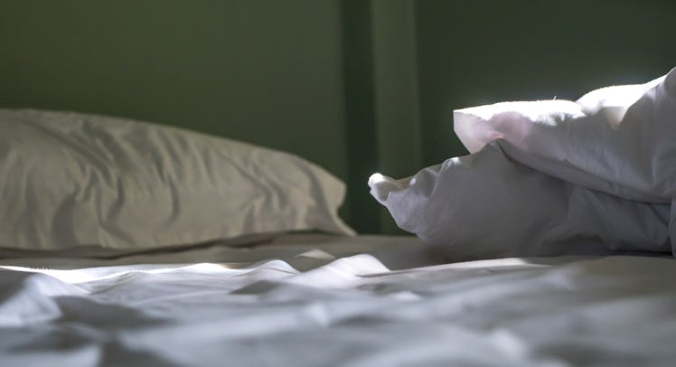 Three white pillows on a white bed sheet