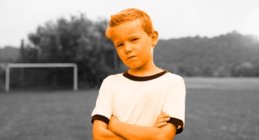 grey scaled edit of a blond haired boy standing arm crossed in a field