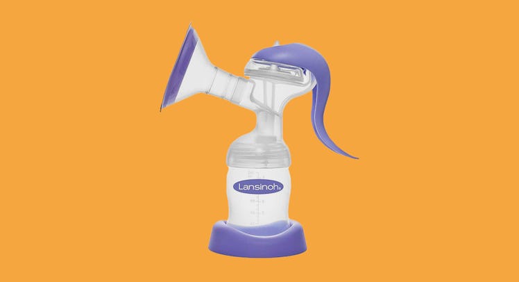 A manual breast pump against an orange backdrop