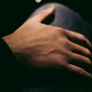 closeup of a man's hand surrounded by shadow
