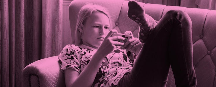A teen lying on the couch while scrolling through Instagram