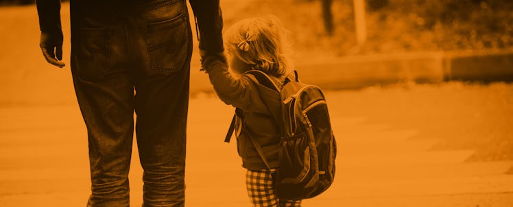 A parent walking with his preschooler kid