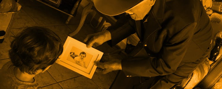 Father and son looking at old photos together