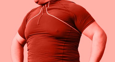 a man with fat man boobs stands with his hands on his hips