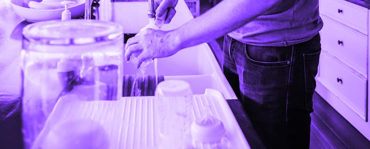 A dad with OCD washing dishes in the kitchen