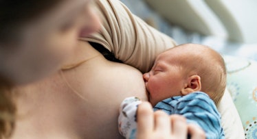 close up shot of a woman breastfeeding a newborn baby