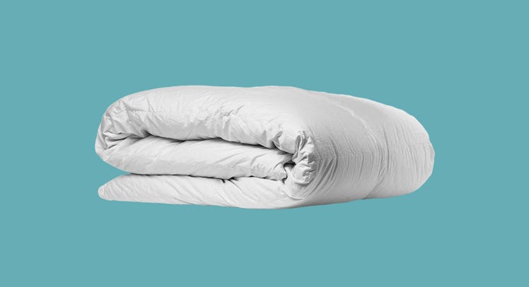The Parachute Down Duvet Insert comforter in front of a blue background