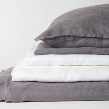 Beddings stacked on top of each other and a pillow