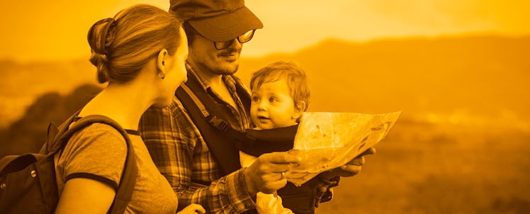 Parents looking at a map while travelling with their baby