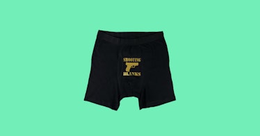Black boxer- briefs that say "shooting blanks" and have a drawing of a gun all in gold 