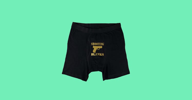 Black boxer- briefs that say "shooting blanks" and have a drawing of a gun all in gold 