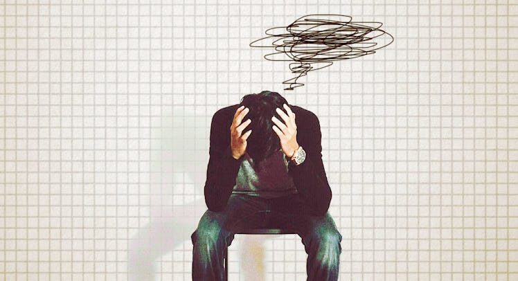 A dad with OCD sitting while holding his head with his hands