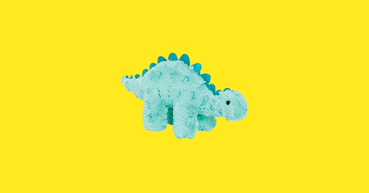A green turquoise dinosaur toy in front of a bright yellow background
