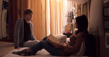 A couple sitting on the bed while talking