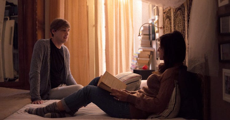 A couple sitting on the bed while talking