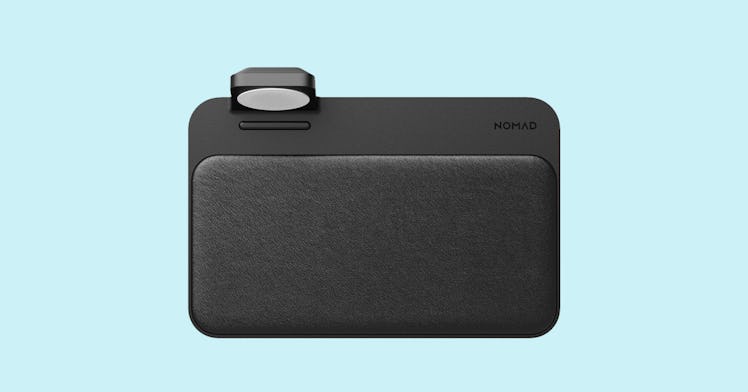 Nomad Base Station apple watch charger, in black against a light blue background.