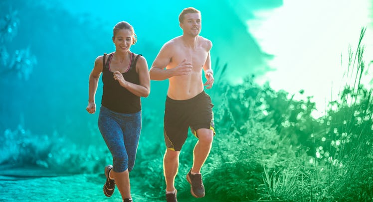 A shirtless man wearing black shorts running next to his wife in a black top and blue sweatpants